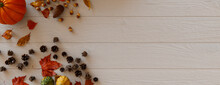 Seasonal Wallpaper, With Autumn Leaves, Gourds And Berries On A White Wood Surface. Thanksgiving Concept With Copy Space.