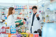 © 2B - Male and female pharmacists talk to check stocks of medicines in pharmacies. communication