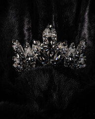 Wall Mural - beautiful silver crown with black stone for miss beauty pageant on black shiny background, close-up
