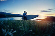 © pikoso.kz - Man with paddle and SUP board near lake at sunset