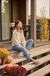 © zinkevych - Pensive young woman seated on the veranda of her cottage