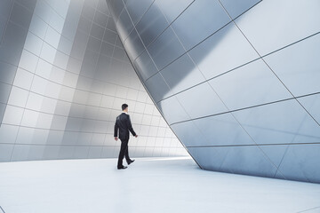 Poster - Businessman walking in abstract glass building open space interior.