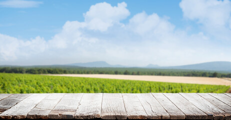 Wooden table with vineyard on back