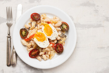 Wall Mural - Salad with Fried cod fish and white beans on the plate.