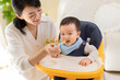 © Blue Jean Images - Young mother feeding baby at home