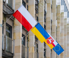 The Flags Of Poland, Ukraine, Lublin Voivodeship And European Union On The Office Business Building Background. Its A Symbol Of Opposition To Russian Aggression, A Sign Of Solidarity And Help Ukraine
