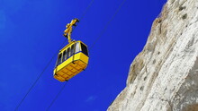 Yellow Сable Funicular Car Lift At Rosh Hanikra Grottoes. Sky And Rock Background.