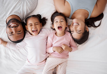 Poster - Family happy, crazy children and above bed with parents in the morning, funny face in the house and comic portrait together in home. Top view of mother and dad smile with girl kids in bedroom