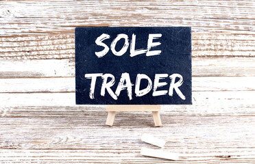 Poster - SOLE TRADER text on the Miniature chalkboard on wooden background