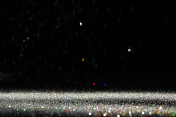 Wall Mural - shiny colorful glitter falling down on black background. bokeh effect