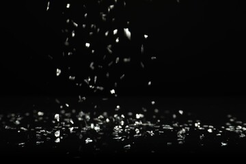 Wall Mural - shiny silver glitter falling down on black background. bokeh effect