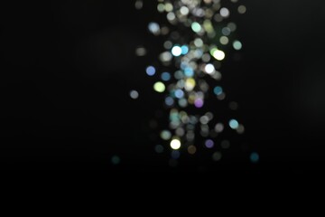 Wall Mural - blurred view of colorful festive lights on black background. bokeh effect