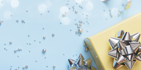 Wall Mural - flat lay christmas and new year gift boxes, pearls and bows top view on blue background
