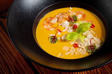 Wall Mural - pumpkin soup with shrimps and herbs