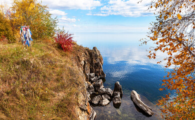 Wall Mural - baikal lake in september. natural landmark shamansky cape. colored tourist ribbons and buddhist pray