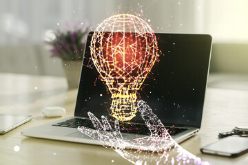 Poster - Creative light bulb hologram on modern laptop background, idea concept. Multiexposure