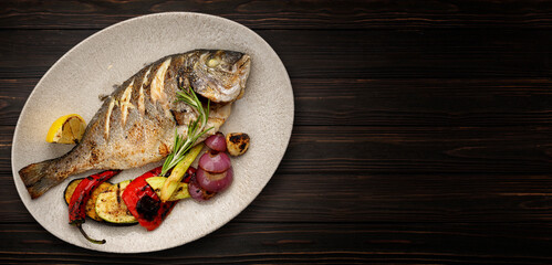 Fried dorado fish with grilled vegetables and lemon