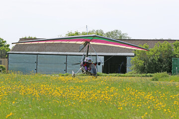 Poster - Ultralight airplane taxiing on a farm strip	