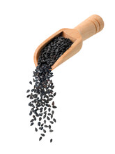 Pouring black sesame from wooden scoop isolated on white background.