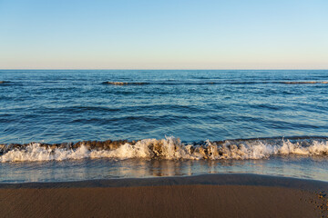 Wall Mural - Small waves on the sea beach. Vacation 2023