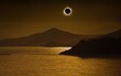 Total solar eclipse in dark red sky above mountains and sea