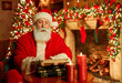 © Seventyfour - Portrait of traditional Santa Claus typing letter in festive room with Christmas decorations, copy space