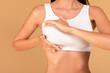 © Prostock-studio - Breast self-screening concept. Young woman in white bra making checkup for cancer prevention, closeup, cropped