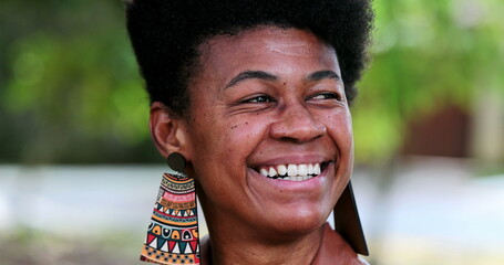 Wall Mural - African woman portrait face close-up standing outside. happy smiling black lady