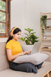 © Daenin - Asian woman working at home on the sofa business woman Business document check, account audit, document search, document preparation, report, analysis, tax, time, accounting, data sheet