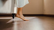 © tirachard - Close-up Asian girl foot step down on bed with white pajamas wake up walk to open curtain on window fresh peaceful morning light empty floor in bedroom at home. Female morning lifestyle concept.