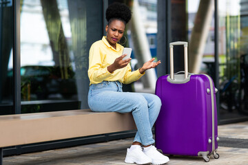 Wall Mural - Displeased African American Woman Tourist Using Smartphone Having Problem Outside