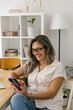 © STUDIO TAURUS - Lifestyle portrait of a businesswoman at home having a video call