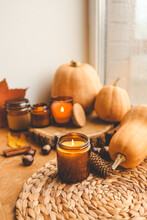 Autumn Still Life On The Windowsill, A Burning Candle, Pumpkins And Candles