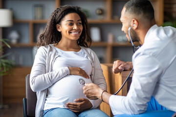 African american man doctor doing checkup for pregnant lady