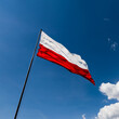 The red and white flag of Poland flutters in the wind