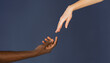 © Svyatoslav Lypynskyy - Interracial communication and cooperation of human being. Black and white male and female hands isolated on blue background. BLM concept. All Lives matter concept