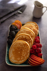 Wall Mural - Pancakes with fruits, berries, chocolate sauce and coconut chips