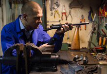 Professional Gun Repairman Performing Disassembly Of Sporting Handgun, Preparing Firearms For Preventive Maintenance.