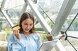 © StockPhotoRepublic - Young asian beautiful female lady making a payment for an online shopping purchase via her digital tablet easily and successful while sitting in a cafe