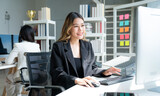 Fototapeta  - Successful asian businesswoman working and looking camera at her office desk, Concept of business risk analysis and assessment