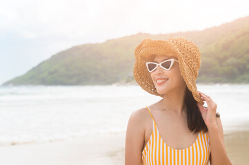 Wall Mural - Young Beautiful woman in Bikini enjoying and relaxing on the beach,  Summer, vacation, holidays, Lifestyles concept.