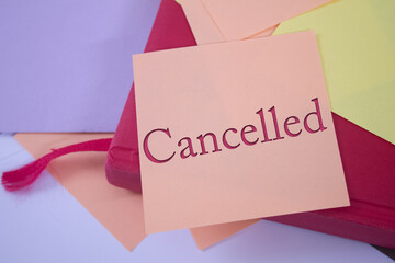 Poster - Cancelled. Text on adhesive note paper. Event, celebration reminder message.