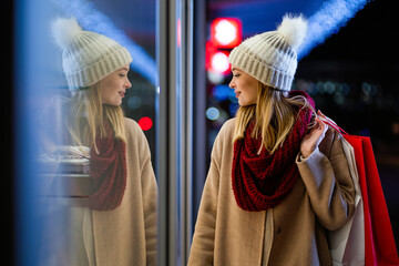 Wall Mural - young happy woman with shopping bags walking on street and buying christmas presents.