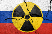 Flag Of Russia Painted On A Concrete Wall With Nuclear Weapon Sign. Russian Military Aggression
