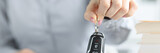 Agent holds keys to car and inscription insurance closeup