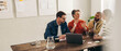 Leinwandbild Motiv Creative businesspeople having a discussion using a laptop in an office