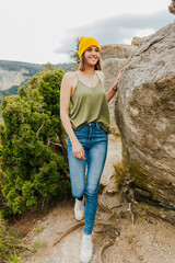 Wall Mural - Portrait of beautiful happy girl enjoys on top of rocky mountain lake. Adventure, travel, holiday concept.