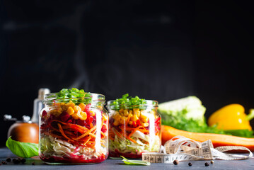 Poster - Fresh salad of autumn vegetables - purple and green cabbage, carrots, green onions. salad in bank