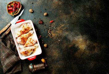 Canvas Print - Raw uncooked chicken legs, drumsticks in bowl, meat with ingredients for cooking