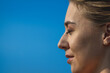 © DenisLubsanov - closeup portrat of smiling blonde caucasian woman against the blue clear sky